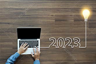 Creative light bulb idea 2023 new year, With businessman working on laptop