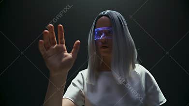 Cyber girl play simulation game in vr glasses closeup. Futuristic player touch