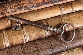 Rusty key on old books