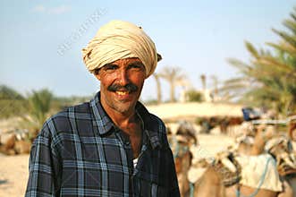 Sun-tanned man in turban smiles