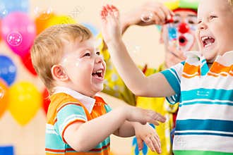 Playful kids boys with clown on birthday party