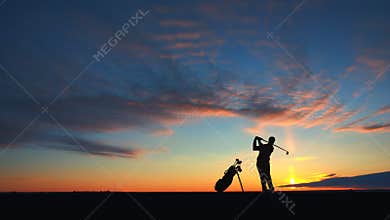 Man golf player hit ball to air silhouetted