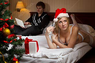 Young woman in Santa's hats remain all alone