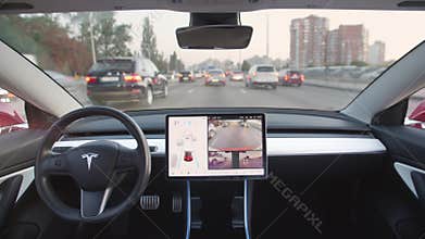 Futuristic Tesla vehicle with autonomous steering feature drives itself