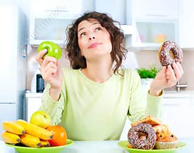 Diet. Woman choosing between Fruits and Sweets