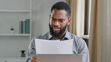 Serious African American man ethnic bearded businessman boss entrepreneur bookkeeper executive in office holding papers