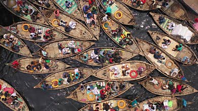 Boats filled with travelers crossing the river to their workplace.