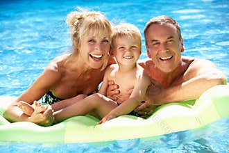 Grandparents And Grandson In Swimming Pool