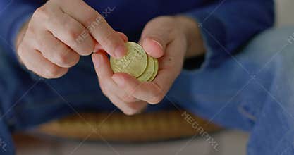man with some bitcoins in his hands in closeup