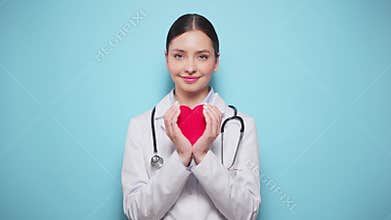 Female doctor cardiologist showing heart symbol