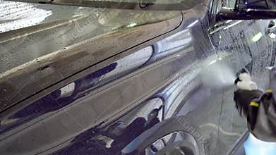 Close-up of interior cleaning in a car. A worker dirty car water blaster with a vacuum cleaner. Car dry cleaning.