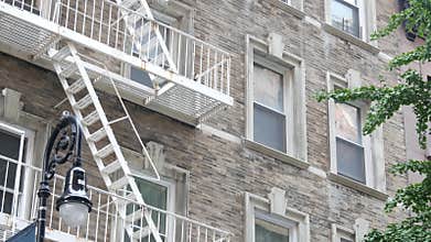 New York City building architecture. Residential house exterior. USA real estate. Fire escape ladder