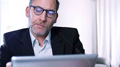 Businessman works with ipad - reflections