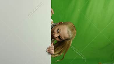 Nice girl peeking from behind blank sign billboard.