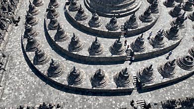 Aerial rotation showing stone stupas arround main big stupa, with detailed close up of the central structure. The unique layout of