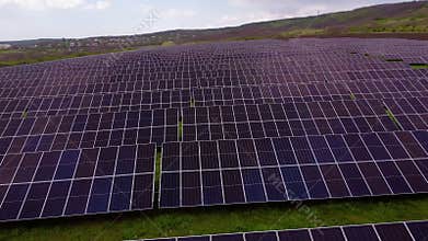 Solar panels absorb sunlight generating energy in vast field