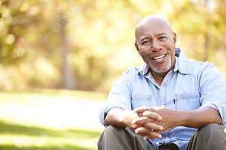 Senior Man Relaxing In Autumn Landscape