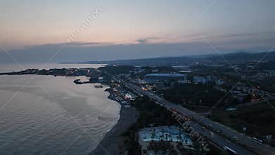 Stunning aerial sunset to night transition over Turkler in Alanya, Turkey. Alanya coastline,resorts,marina,hotels and city lights