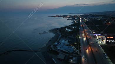 Stunning aerial sunset to night transition over Turkler in Alanya, Turkey. Alanya coastline,resorts,marina,hotels and city lights