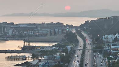 Stunning aerial sunset to night transition over Turkler in Alanya, Turkey. Alanya coastline,resorts,marina,hotels and city lights