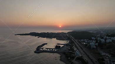Stunning aerial sunset to night transition over Turkler in Alanya, Turkey. Alanya coastline,resorts,marina,hotels and city lights