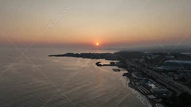 Stunning aerial sunset to night transition over Turkler in Alanya, Turkey. Alanya coastline,resorts,marina,hotels and city lights