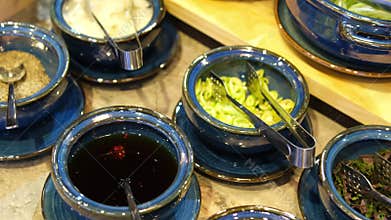 Sauces condiments utensils various spices and additives for oriental asian soup cabbage lime meat in blue plates with