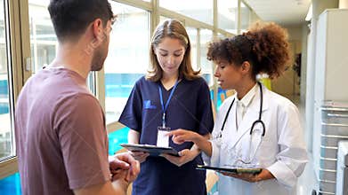 Medical consultation, doctor and nurse discussing patient information