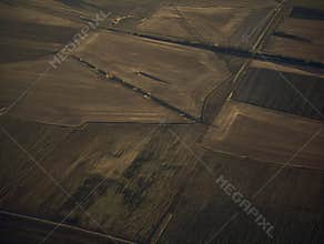 Aerial view of geometric farmland patterns at sunset