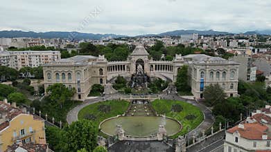 Aerial view of Palais Longchamp in Marseille, France. The historic building features ornate architecture, a central fountain