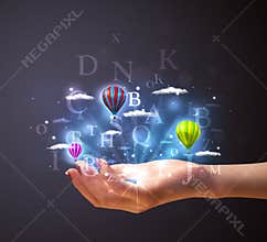 Letters and balloons in the hand of a woman