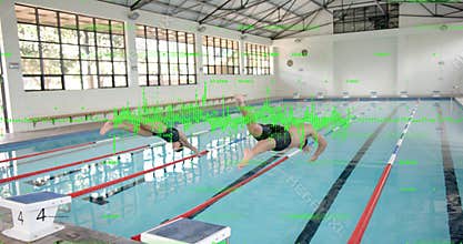Two swimmers crouching at starting blocks and diving into lanes after start signal for competition