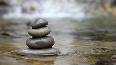 Stacked pebbles and flowing river