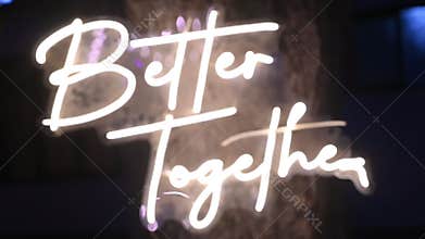 Neon sign displaying better together message