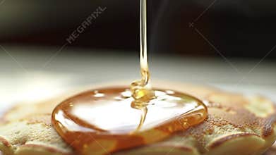 Honey pouring onto pastry close up