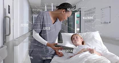 Female nurse entering and reviewing streaming AR data overlays on tablet for patient reassurance