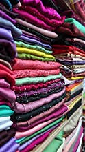 Colorful fabrics displayed in vibrant market stall