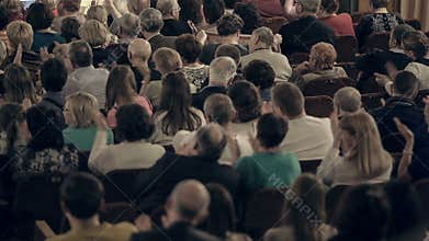 Panning shot of people applauding