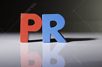 Multicolored word PR made of wood.