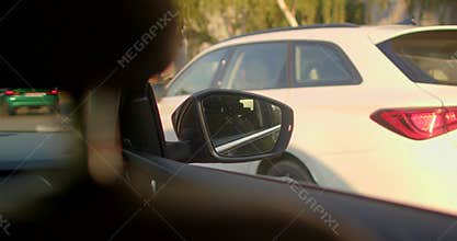 A car journeys through city streets, blending urban life and nature