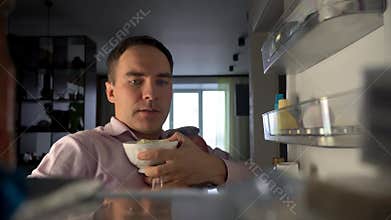 Hungry adult Caucasian businessman entrepreneur man after work open empty refrigerator. POV point of view from inside