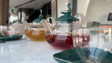 Freshly brewed slimming herbal tea in glass teapot. Beverage for those aspiring for slender figure. Experience benefits