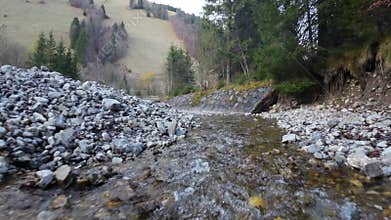 Drone footage of a river flowing in Val Pusteria valleyon a winter day in Alto Adige, Italy