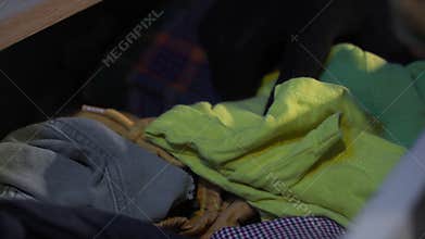 home security, male thief wearing gloves rummaging through things at night