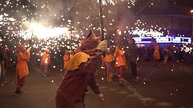 Barcelona, Spain - 20 January 2025: traditional catalan Correfoc, people dressed as devils with firecrackers, in slow motion