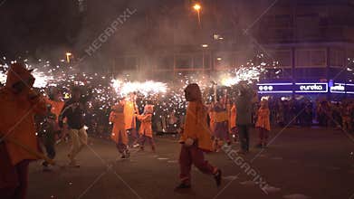 Barcelona, Spain - 20 January 2025: traditional catalan Correfoc, people dressed as devils with firecrackers, in slow motion