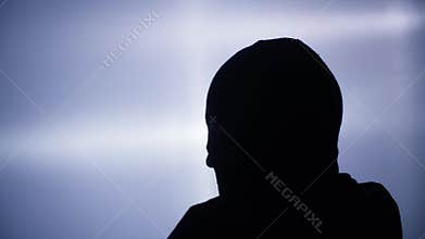 A criminal, a male thief wears a balaclava to hide his identity