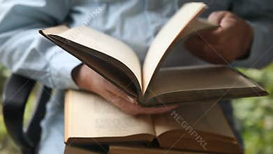 Man with books in lap