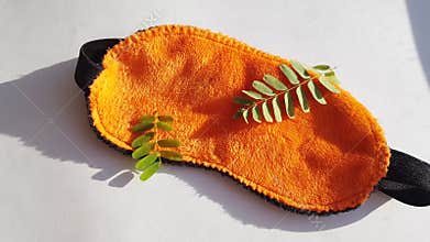 Camera movement over a soft orange eye mask lying