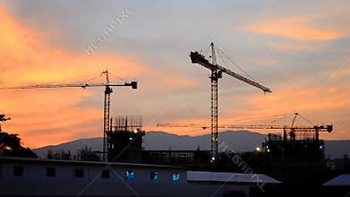 Time lapse silhouette crane building and dusk time